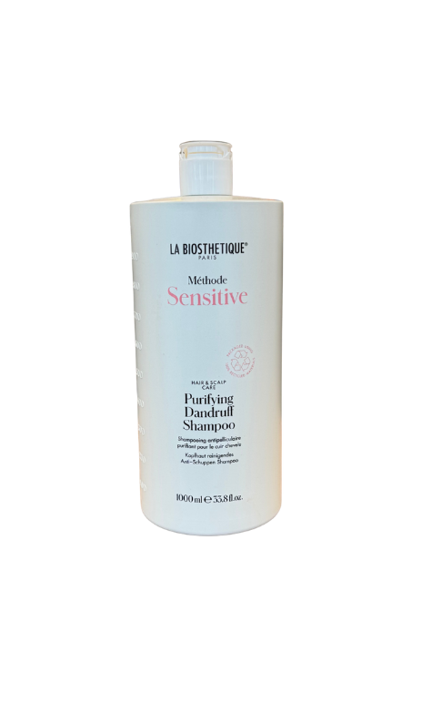 White La Biosthétique shampoo bottle labeled 'Sensitive' for purifying dandruff, on a black background.